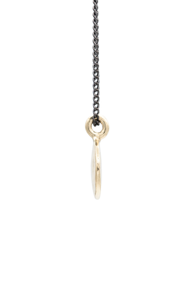 
            
                Load image into Gallery viewer, Vintage Simple Hammered Circle Charm Necklace made of gold plated solid brass giving it a beautiful golden look. The pendant charm is on an oxidized brass chain. Hand made by jewelers in Brooklyn New York
            
        